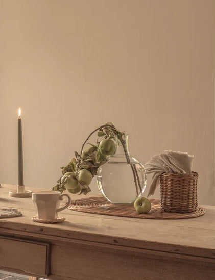 Dining table with rattan placemats, coasters and utensil holder